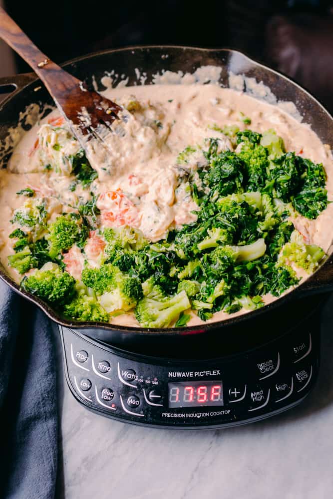 broccoli and spinach to creamy sauce 