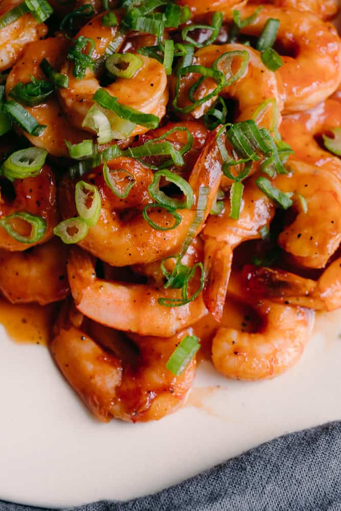 upclose shot of keto bbq glazed shrimp with green onions