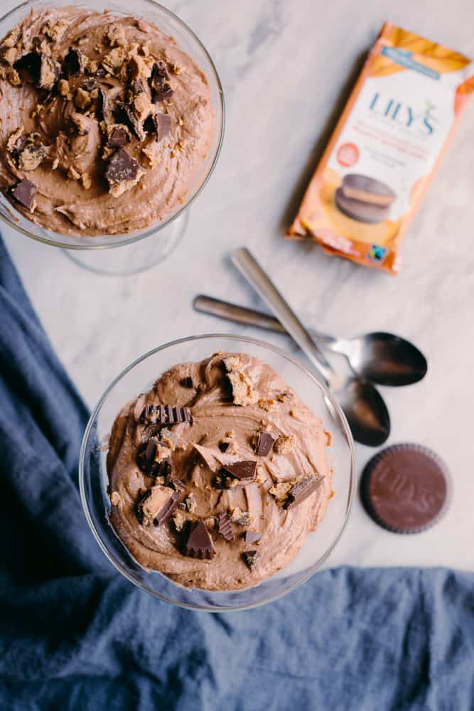 Low Carb Chocolate Peanut Butter Mousse in two glasses with spoons and Lily's peanut butter cups