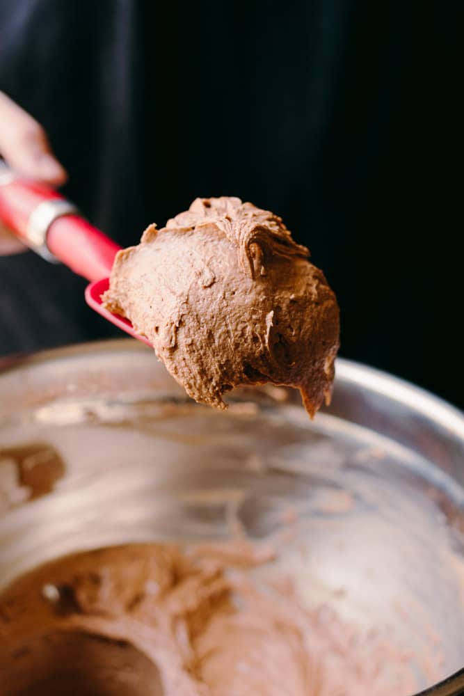 scooping up the low carb chocolate and peanut butter mousse with a rubber spatula