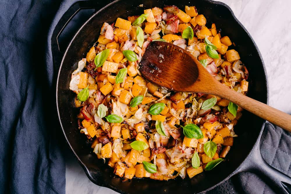 rutabaga cabbage bacon leeks with basil in a cast iron skillet