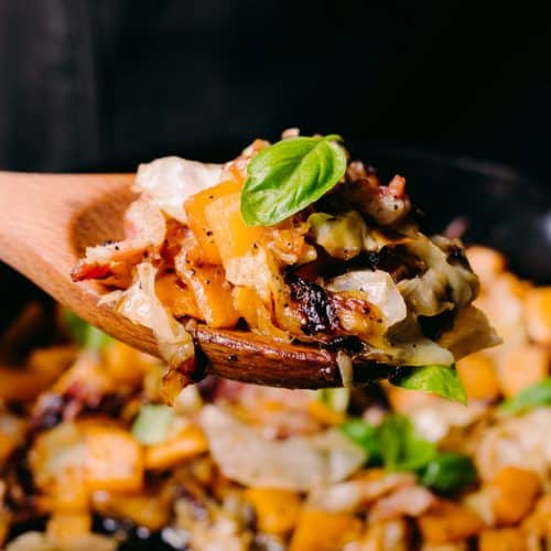 roasted root vegetable hash on a wooden spoon