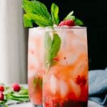 Sugar free keto raspberry mint julep with mint and raspberries in the background