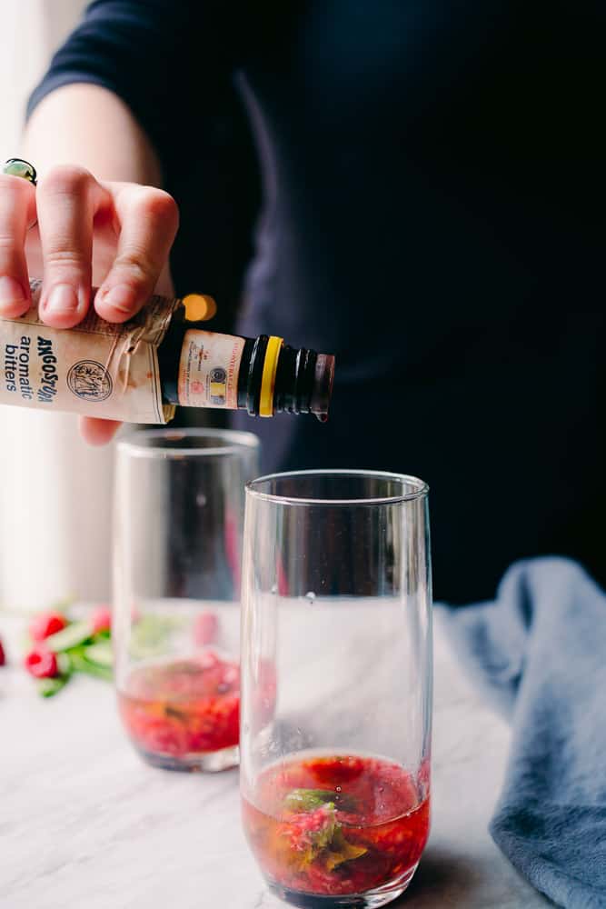adding angosturra bitters to a cocktail