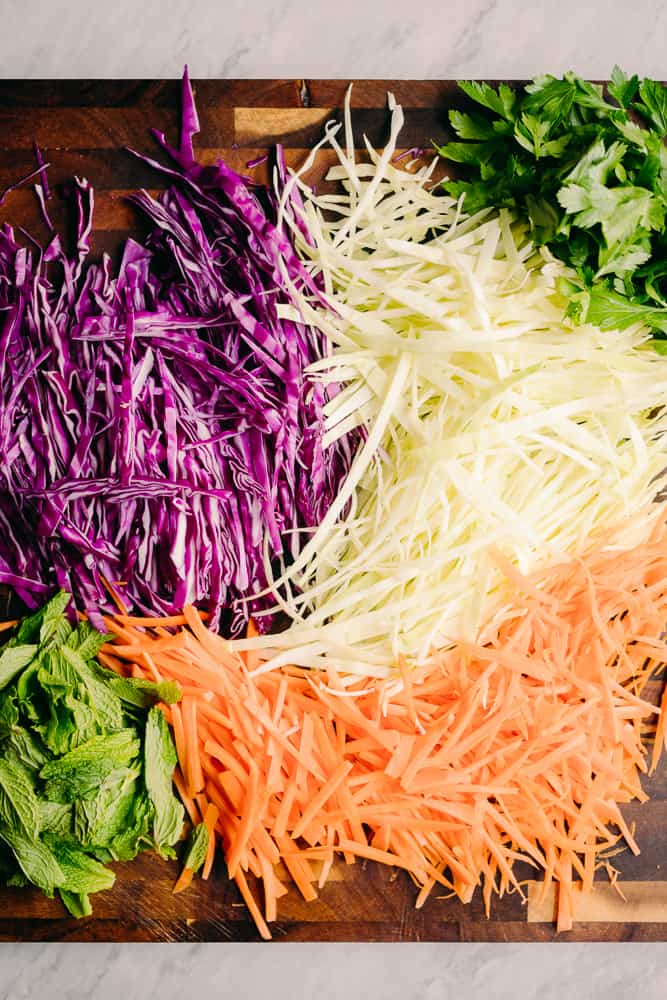 shredded purple and green cabbage, shredded carrots, and mint