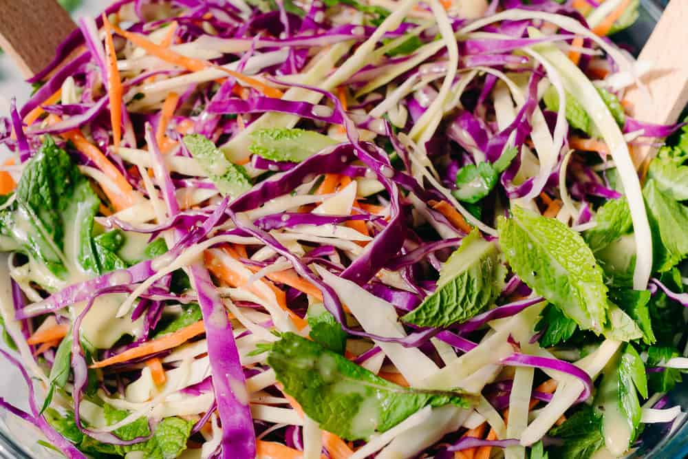 cabbage carrot and herb salad up close with salad dressing