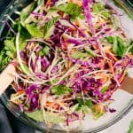 purple cabbage carrot shreds and mint in a salad bowl