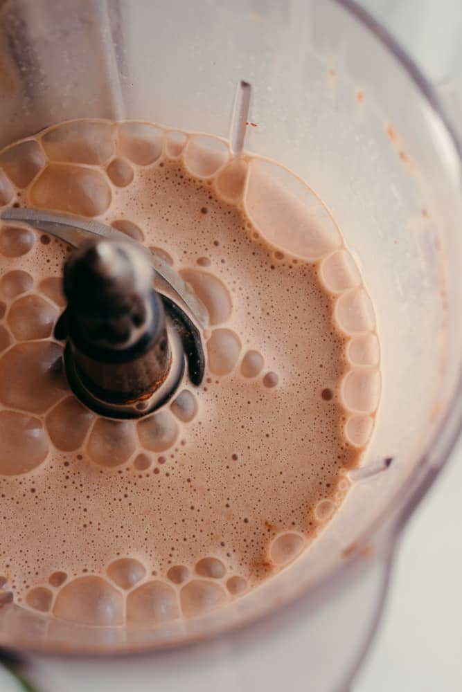 bubbling chocolate maca elixir drink in a blender