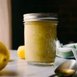 honey lemon vinaigrette with lemons and a spoonful with honey
