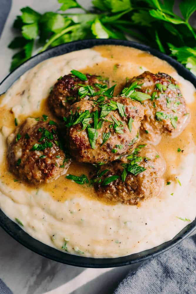 swedish meatballs with gravy on a bed of mashed turnips