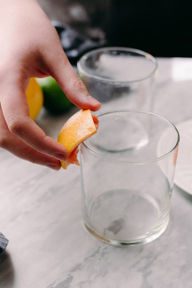 rimming a glass with grapefruit juice