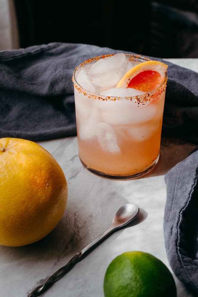 grapefruit and bar spoon with a grapefruit cocktail