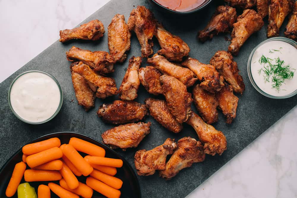 baked crispy buffalo wings with carrots and blue cheese dressing
