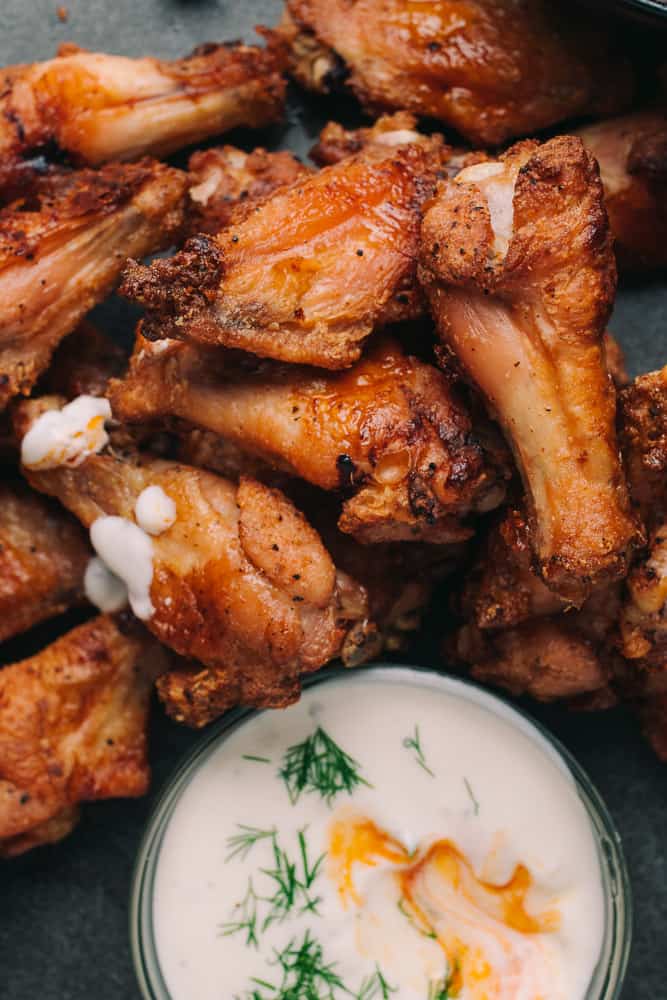 baked chicken wings with ranch dressing on them