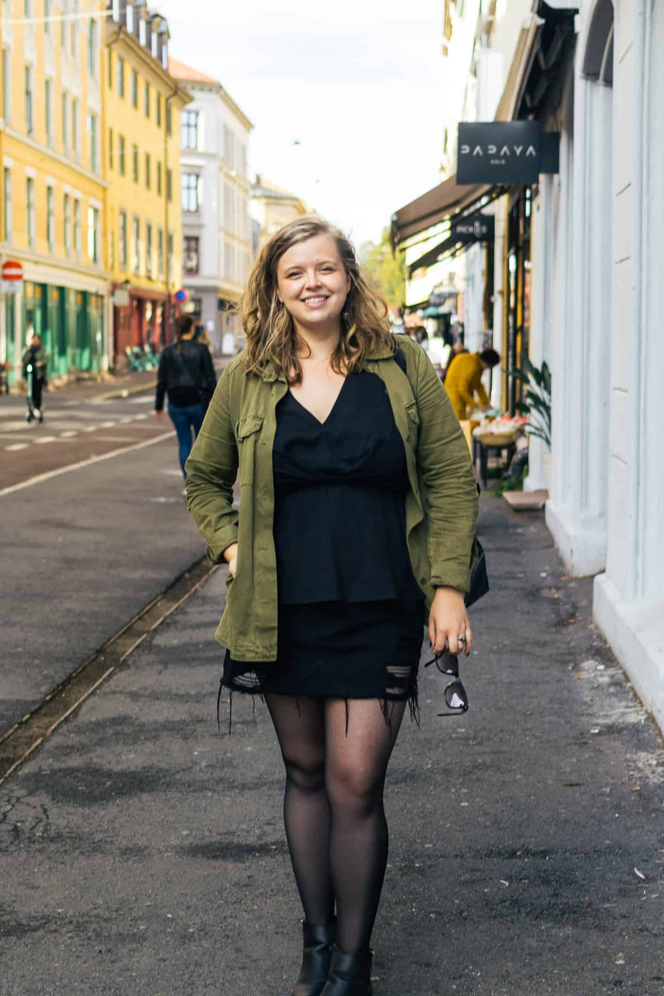 Briana standing in green coat in Norway