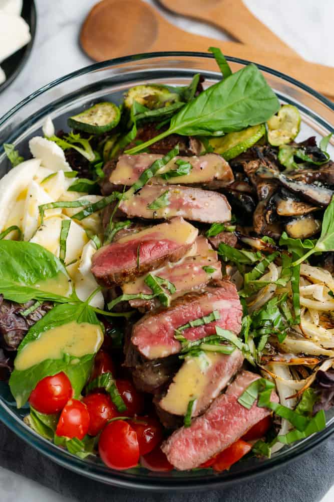 sirloin steak salad with lots of veggies, basil and mozzarella