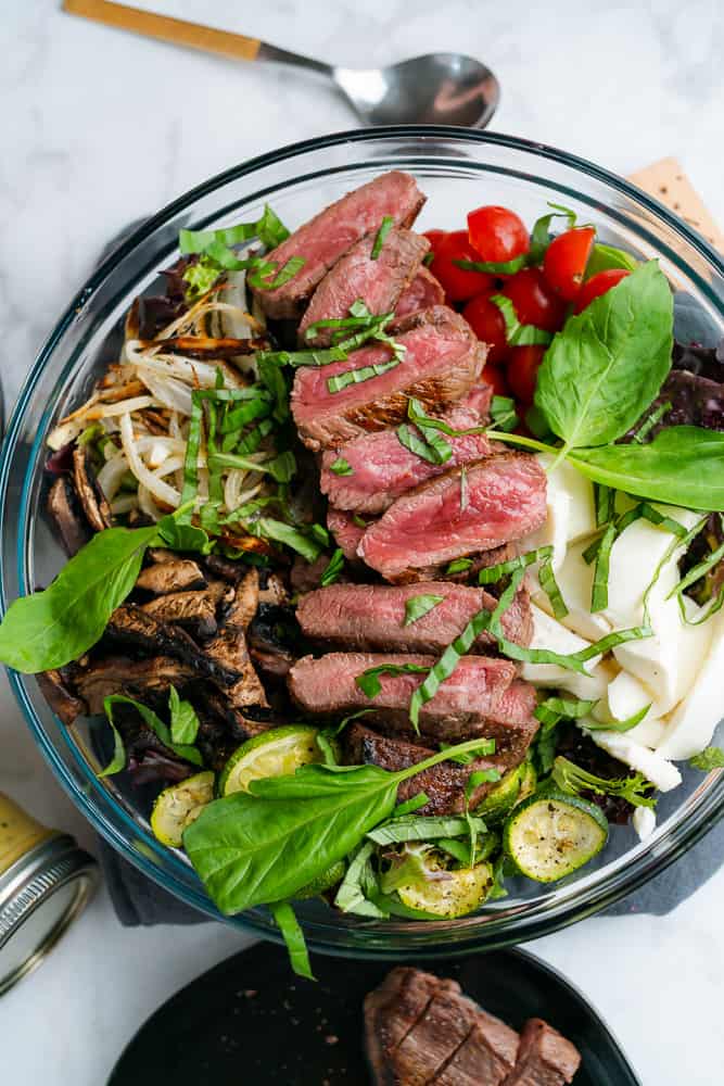 beautiful steak salad with vegetables and basil