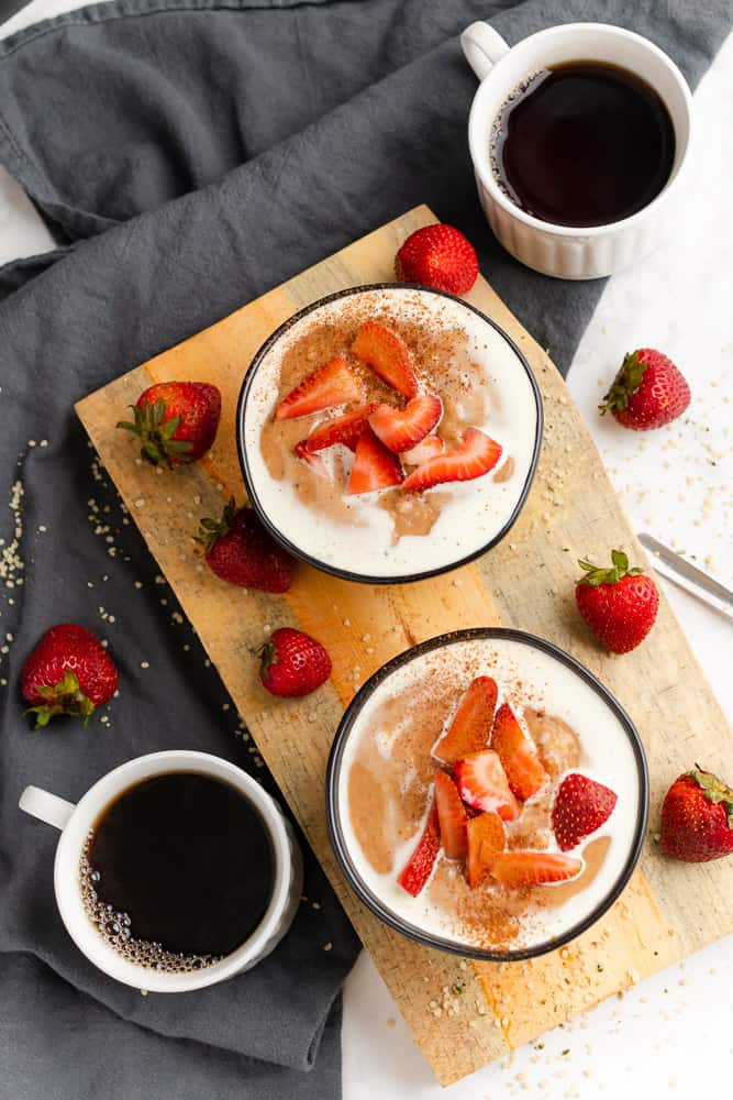 two bowls of strawberry hemp heart oatmeal with coffee