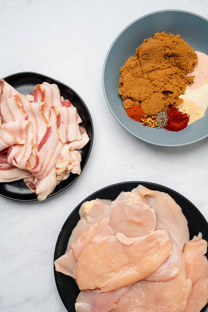 raw chicken and bacon with seasonings