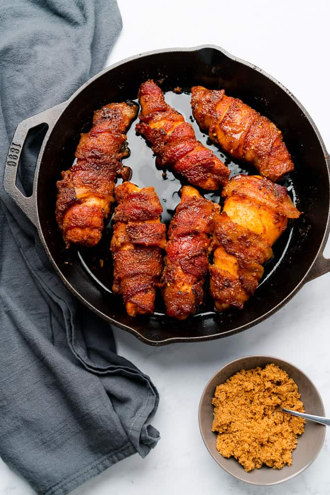 bacon wrapped chicken with brown sugar replacement in a cast iron skillet