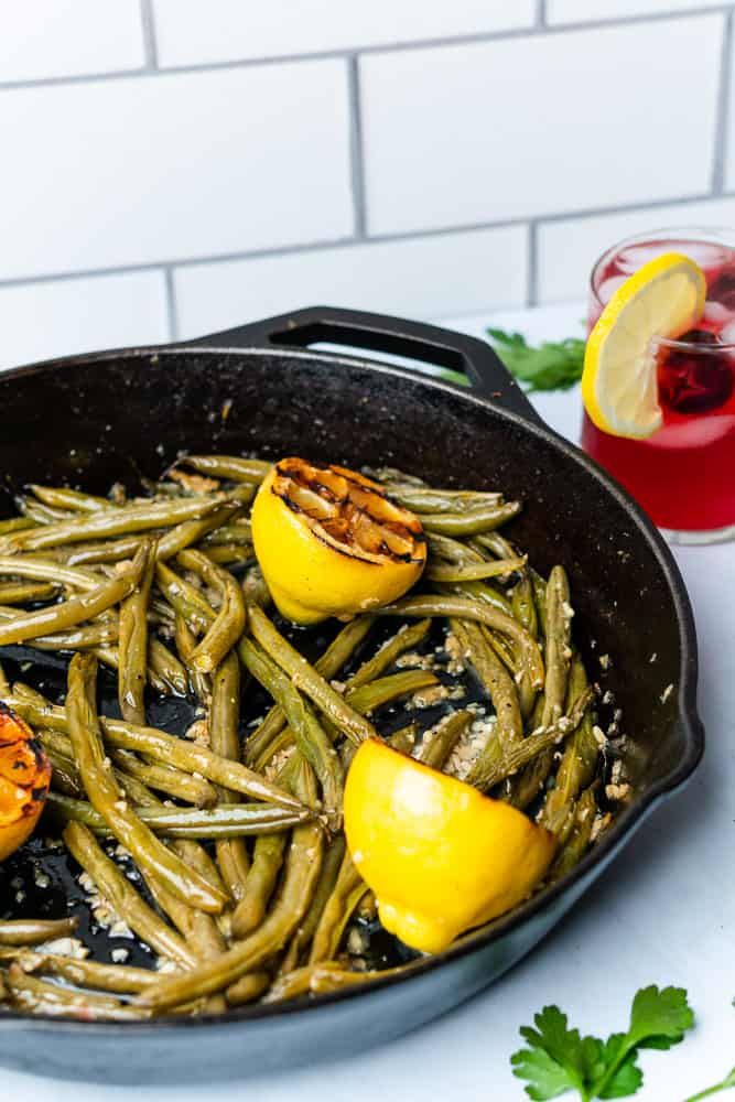 skillet of green beans with a cherry lemonade