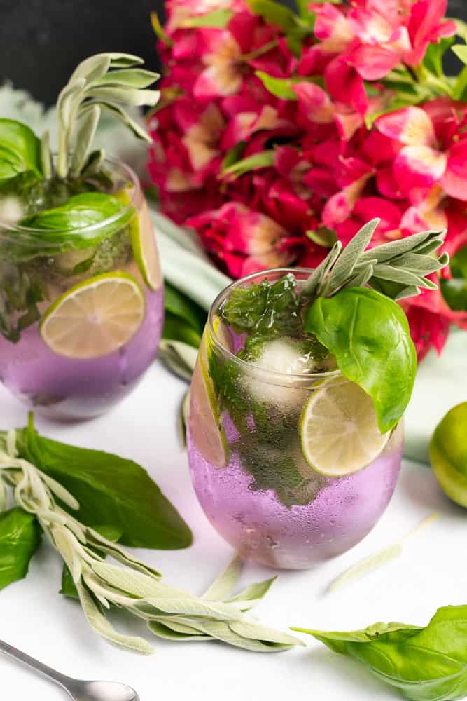 summer herb gin and tonic with pink flowers sage and basil