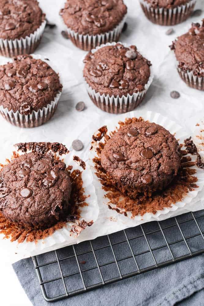 delicious chocolate muffins with white parchment paper and a cookie rack