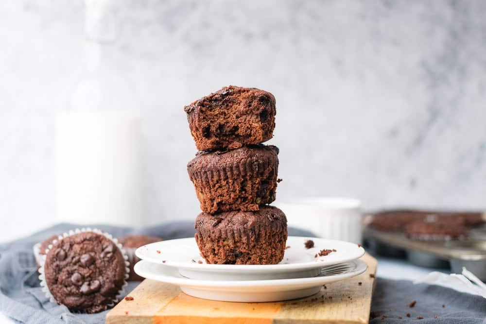 stack of chocolate muffins on a couple of plates 