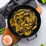 roasted shishito peppers with creamy aioli in a cast iron skillet