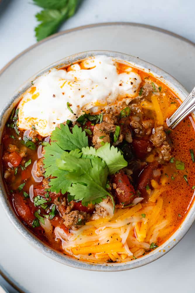 spoonful of turkey chili in a grey bowl