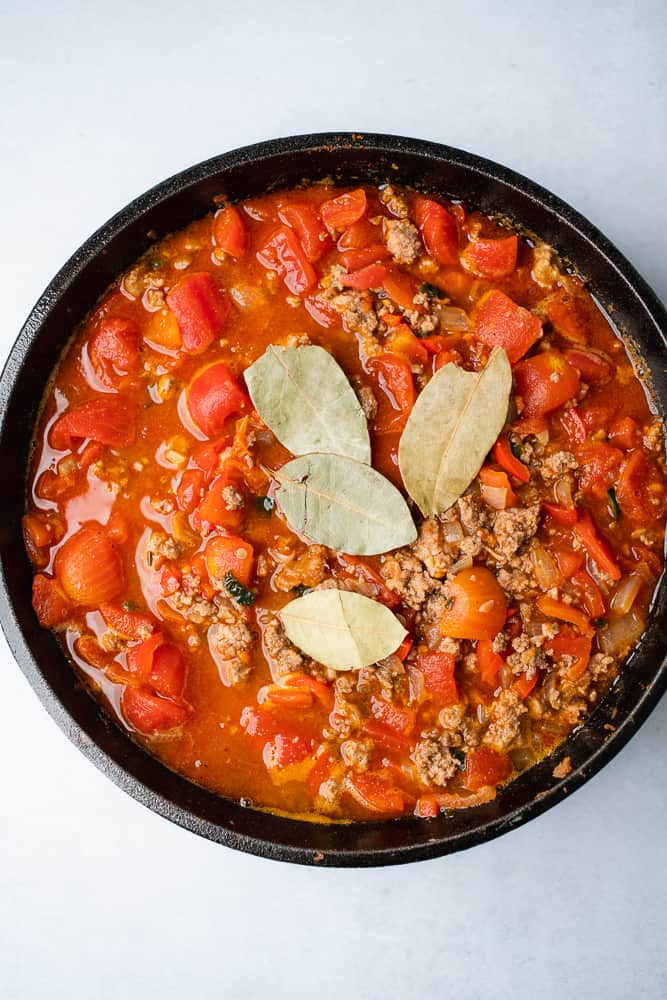 chili with bay leaves in a cast iron dutch oven