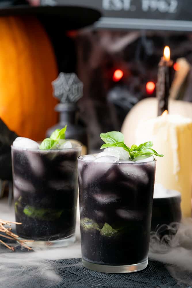 gin blueberry basil smash with halloween decorations