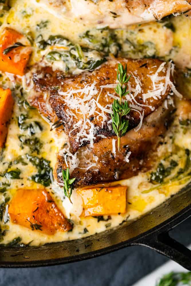 delicious crispy chicken thighs in a cream sauce with spinach thyme and butternut squash