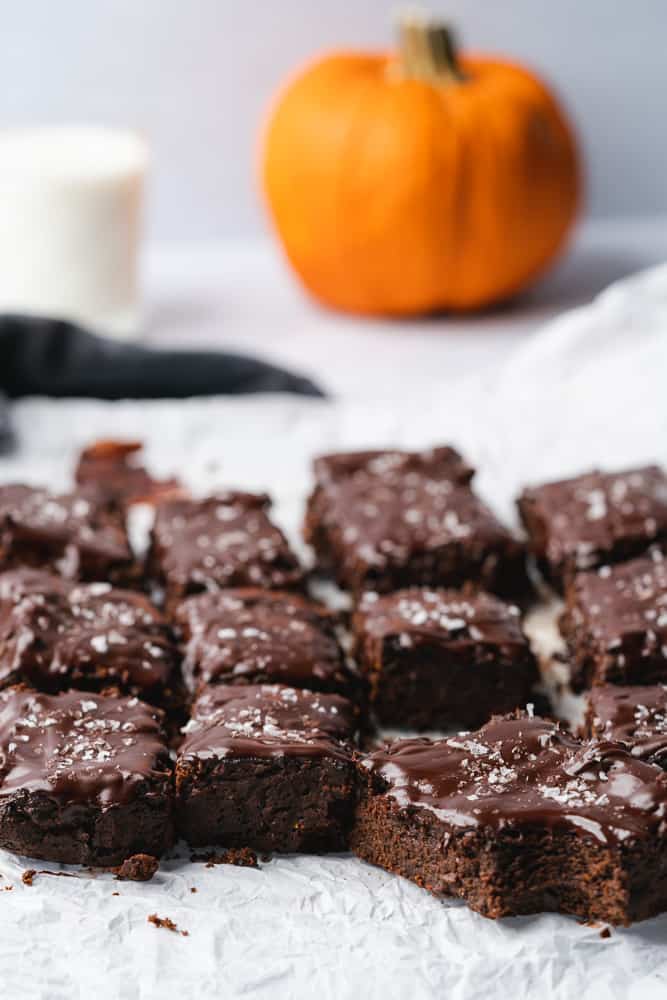 fudgy pumpkin brownies with milk and a pumpkin