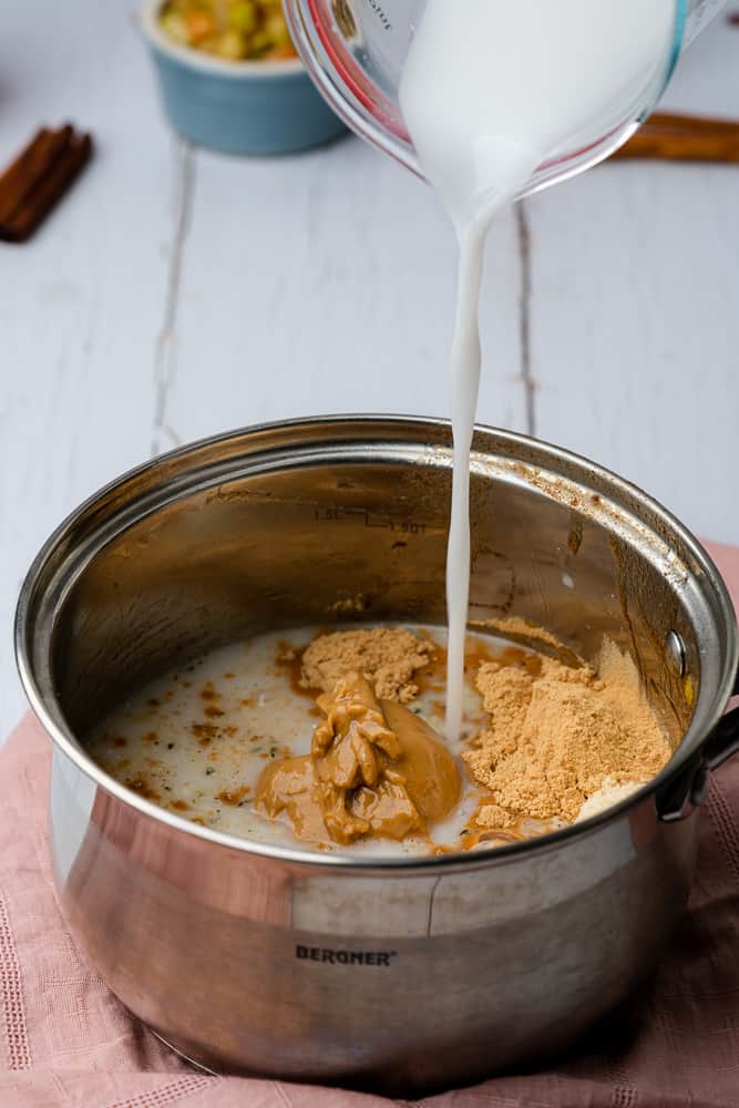 pouring in unsweetened coconut milk to the pan
