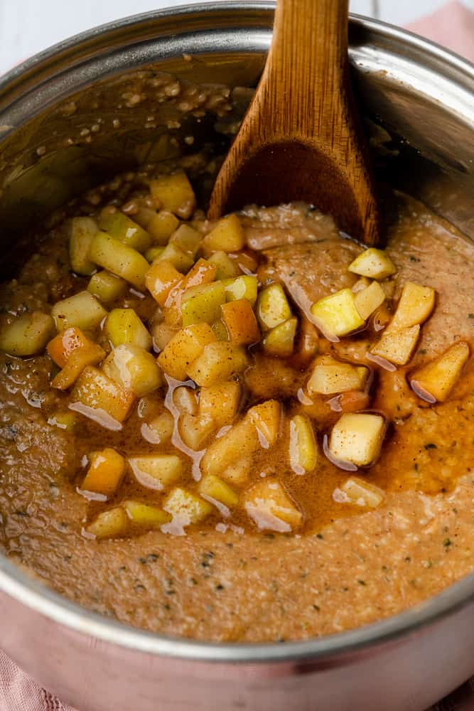stirring in the apple and brown butter zucchini in the hemp heart porridge 