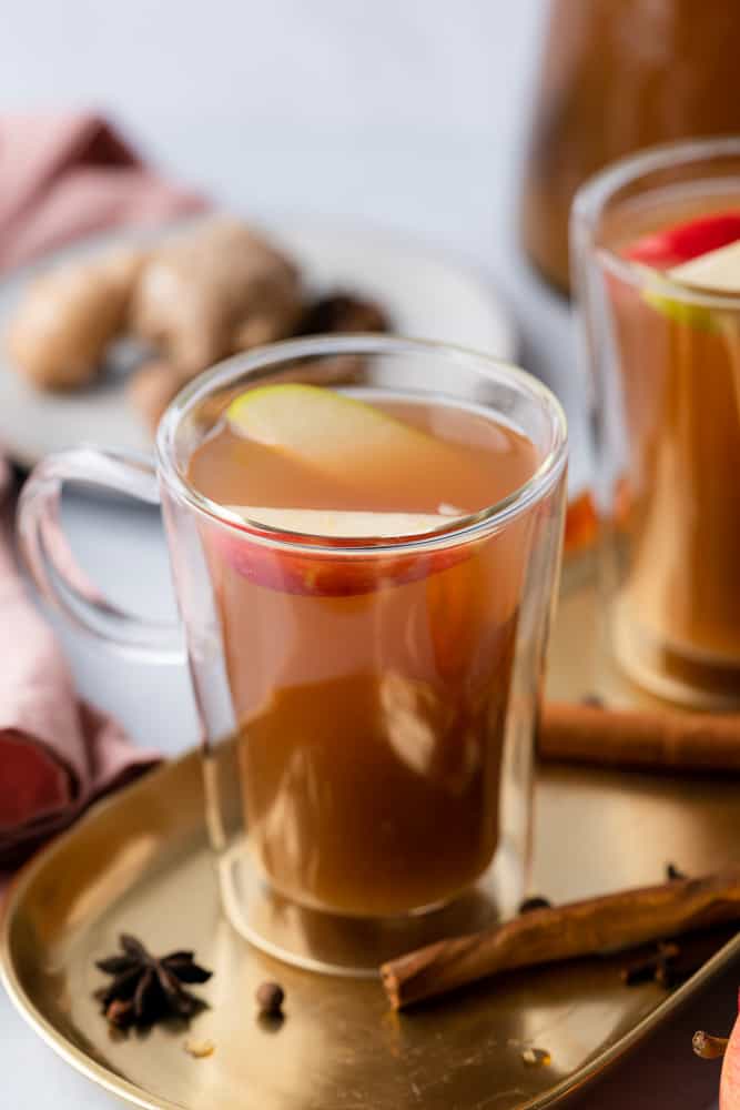two glasses of spiced low carb apple cider with pink towel