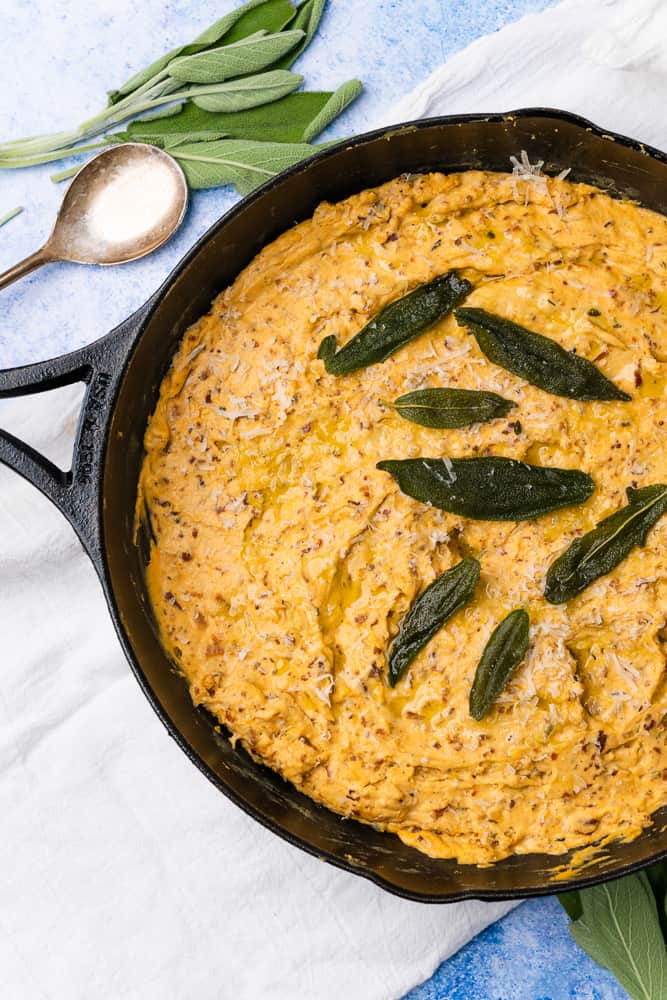 cast iron with baked pumpkin goat cheese dip and sage
