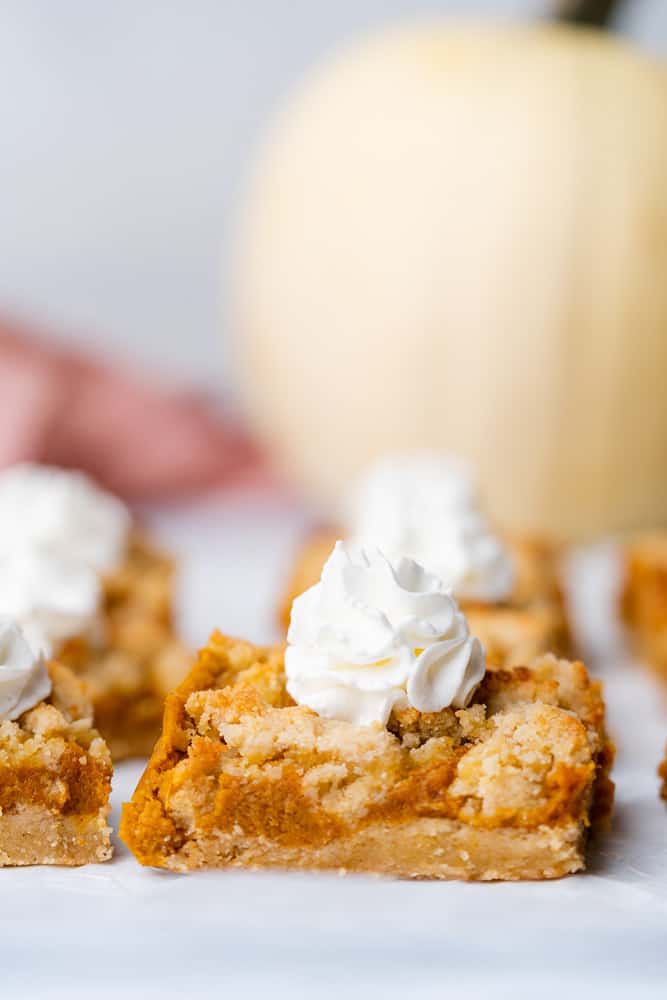 perfect pumpkin pie bars with crumb topping and whipped cream