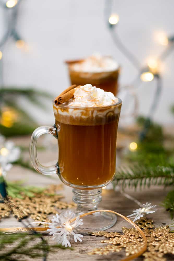 keto hot buttered rum with whipped cream and cinnamon stick