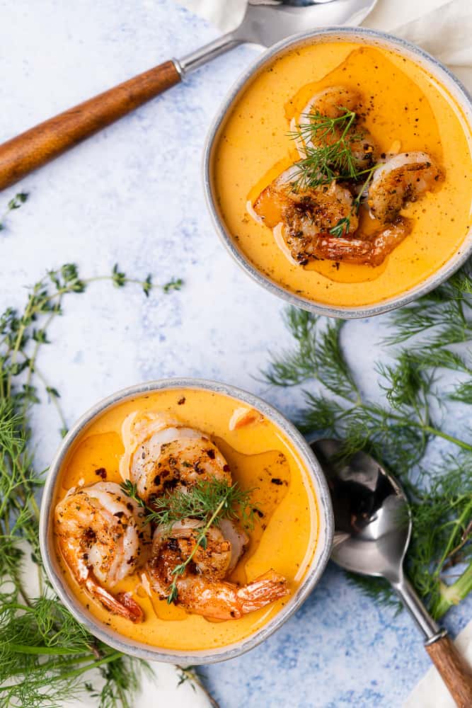 two bowls of spicy shrimp bisque with dill and thyme