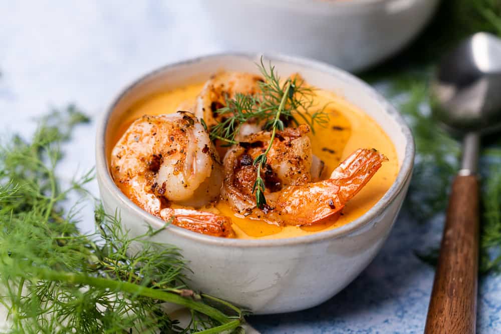 beautiful bowl of shrimp seafood soup with dill and thyme