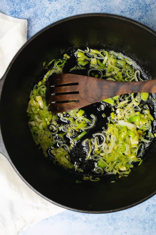 sauteeing leeks with butter in a dutch oven
