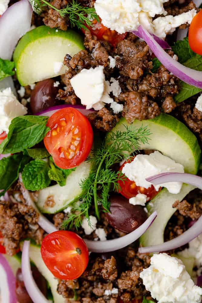 closeup shot of ground lamb feta herbs and tomatoes