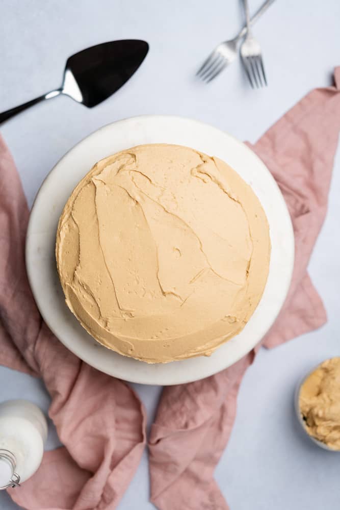 banana dream low carb cake with peanut butter frosting on a cake stand