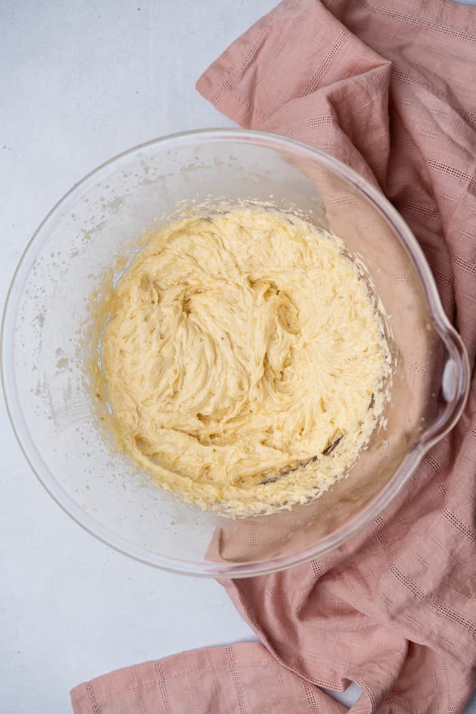 creamed butter  sweetener and bananas in a glass bowl