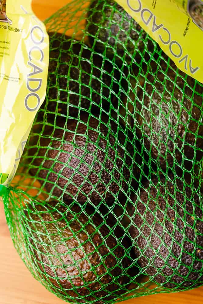 bag of avocados with green netting
