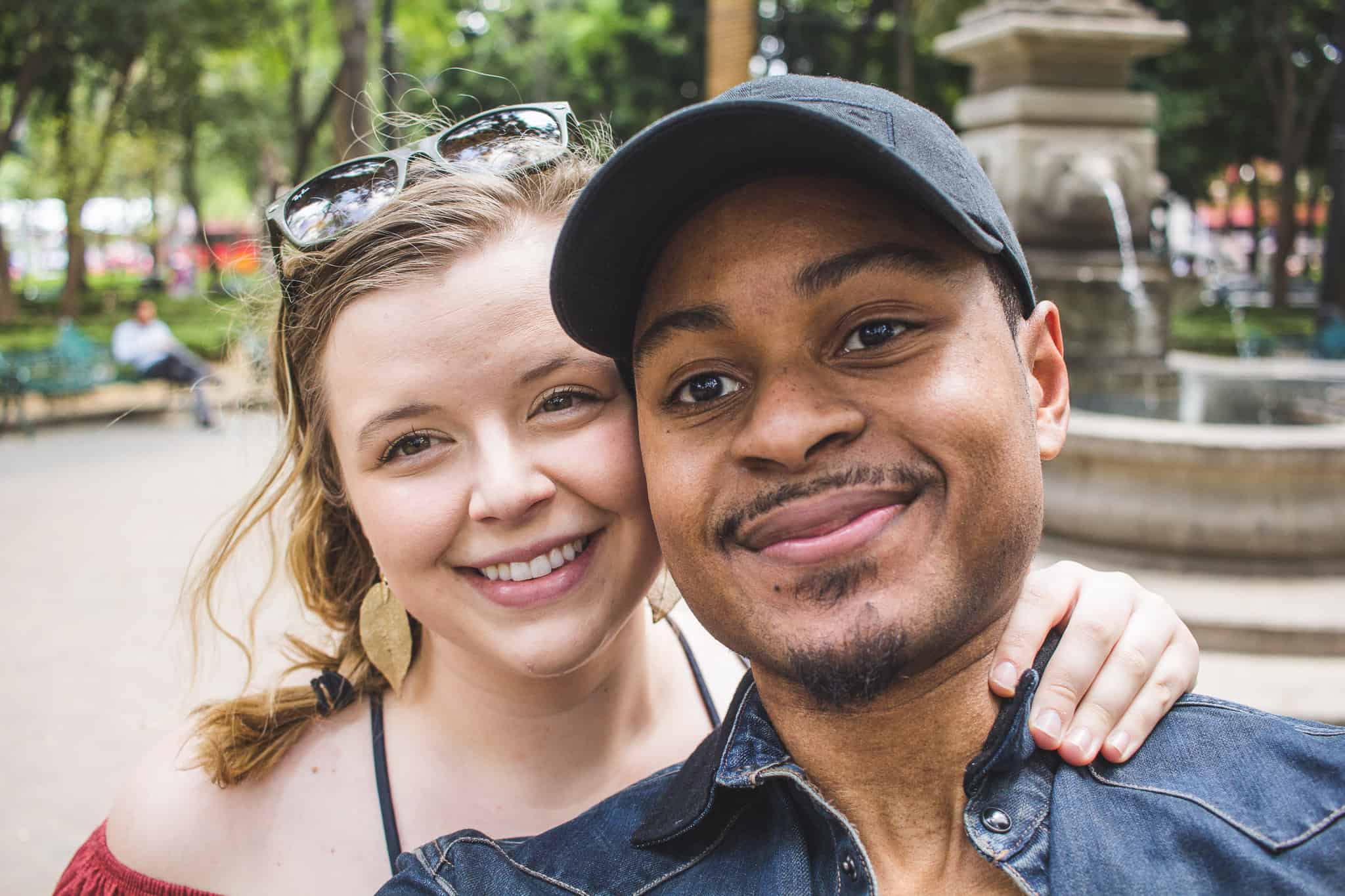 man and woman smiling together in a park in mexico city