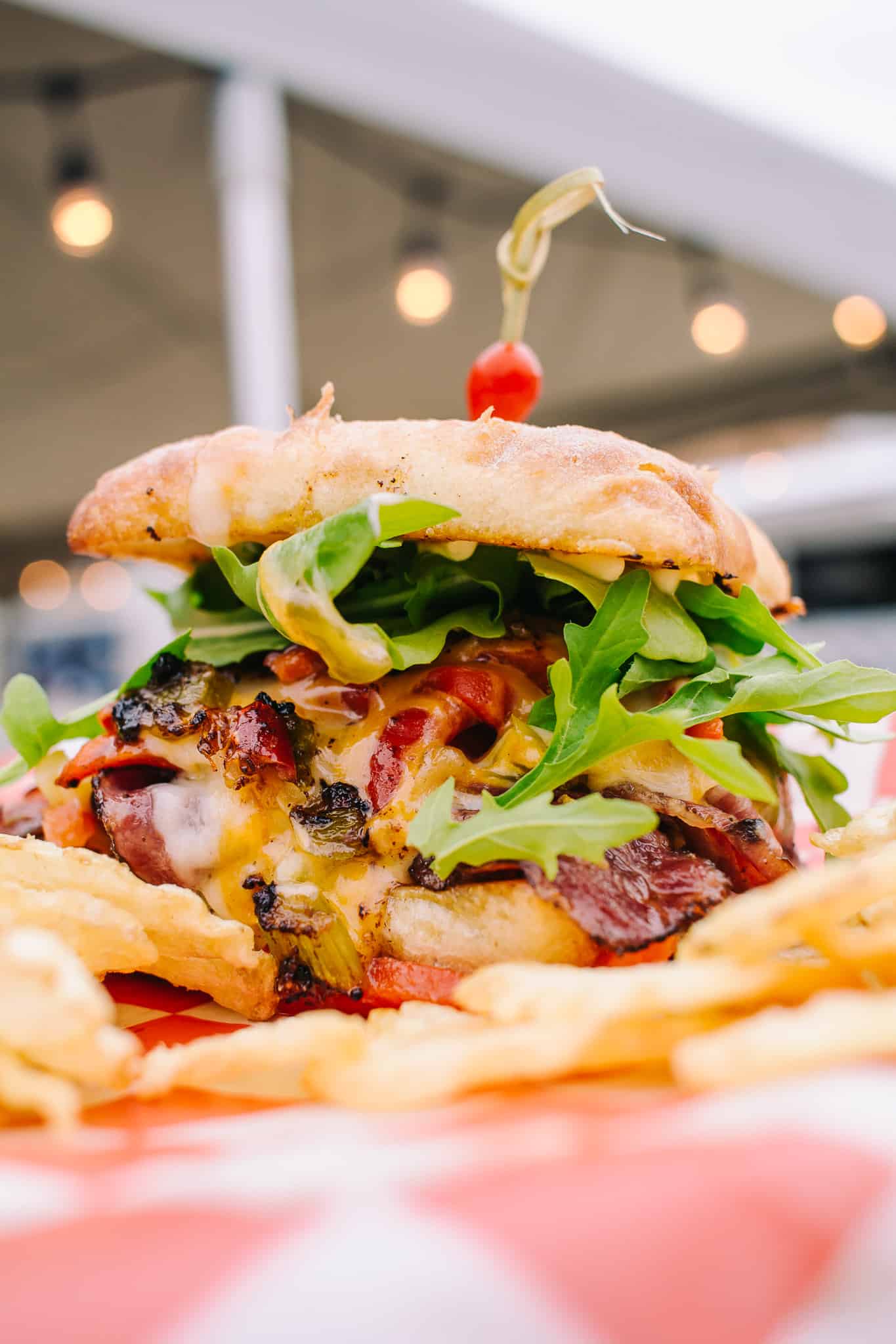 stacked sandwich with lights and bokeh in the background