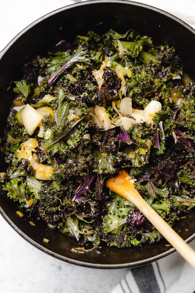 fresh kale in a dutch oven with turnips